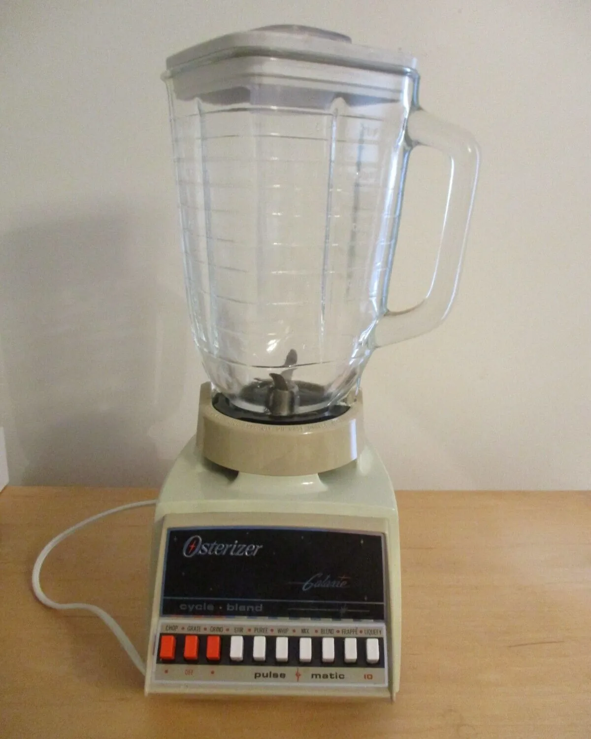 Unplugged worn Osterizer blender beside tools on a repair workbench
