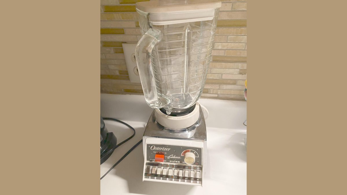 Vintage chrome Osterizer blender beside a modern blender on a kitchen counter