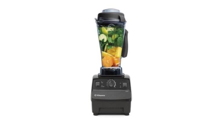 The Vitamix 5200 blender sits ready on a modern kitchen counter with fresh ingredients.