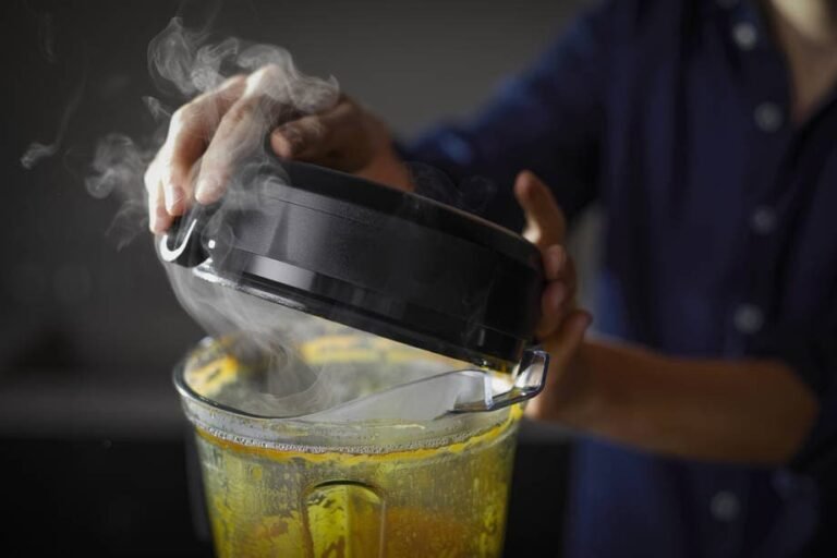 Vitamix blender filled with fresh carrot soup on a clean kitchen counter