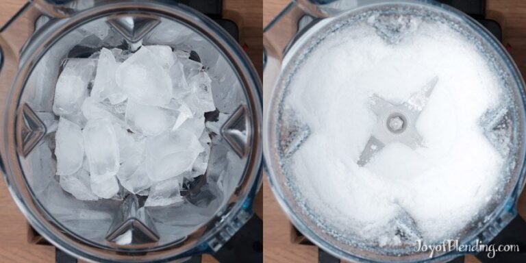 Vitamix blender filled with ice cubes and strawberries on a clean kitchen counter