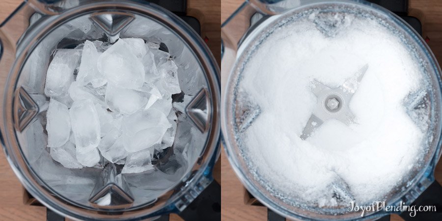 Vitamix blender filled with ice cubes and strawberries on a clean kitchen counter